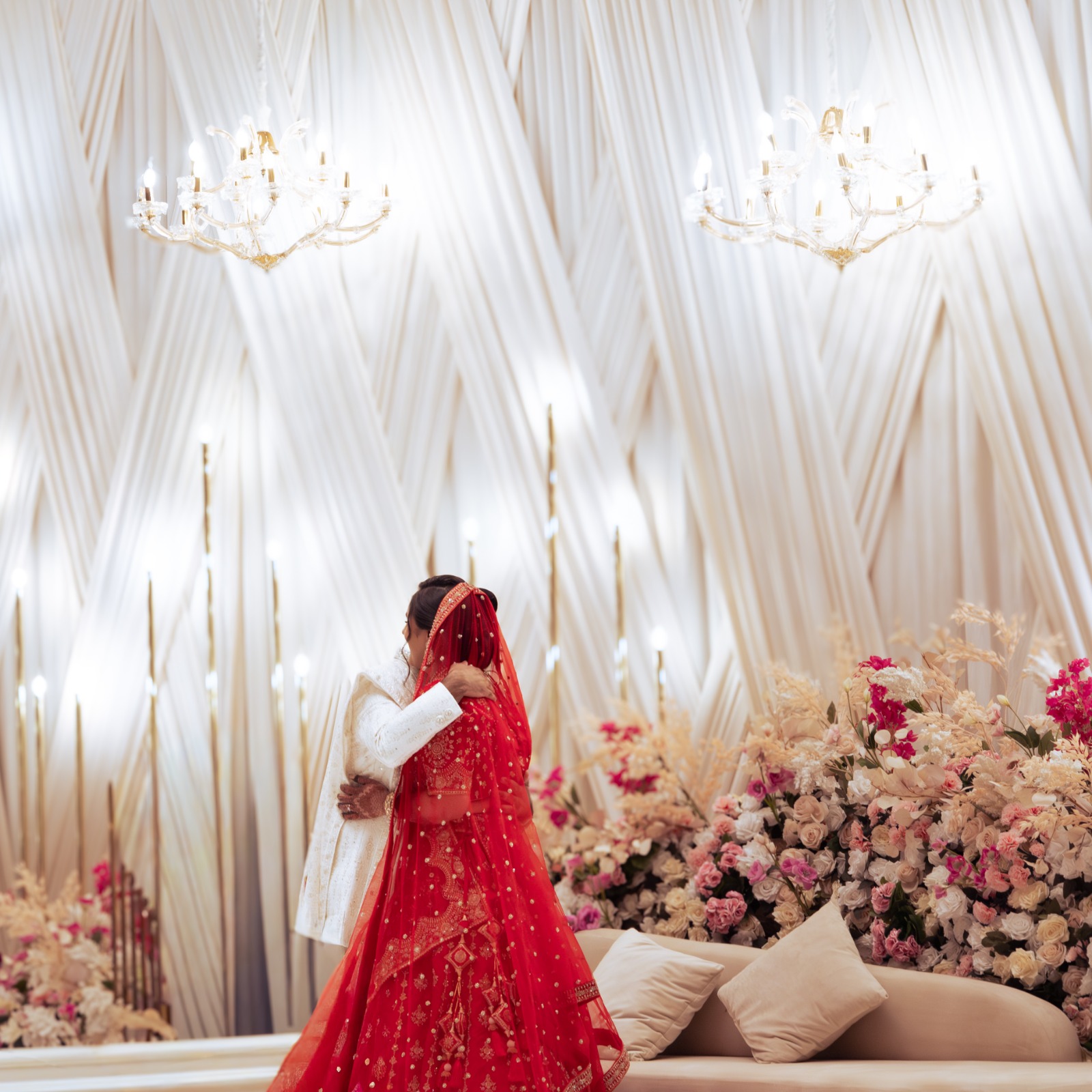 Bride and groom embracing on a wedding stage